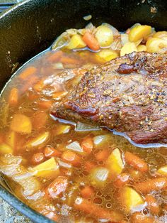 a pot filled with meat and vegetables on top of a stove