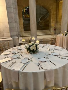 the table is set up with place settings for guests to sit down and enjoy their meal