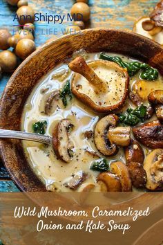 a bowl filled with mushrooms and spinach soup on top of a blue wooden table