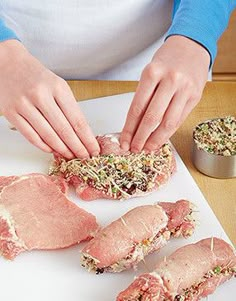 a person preparing raw meat on a cutting board with spices and seasoning in the background