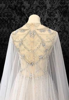 the back of a wedding veil with beading and sequins, on a mannequin dummy