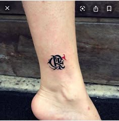 a person's foot with a small tattoo on the lower part of their leg