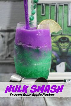 a purple and green drink sitting on top of a wooden table