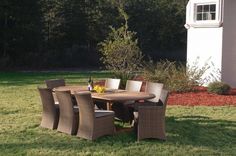 an outdoor table and chairs in the grass