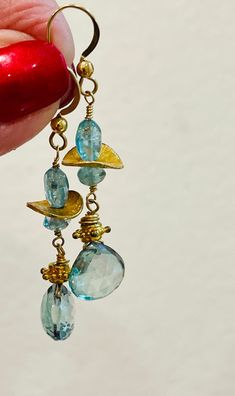 Topaz Earrings Gold dangle drop Earrings Blue gemstone earrings November birthstone by Gem Bliss.  Please note the actual sizes /details given as items may look different depending on your display.  * Images are enlarged to show detail.  ~ 14K Gold-filled Hook earrings.  ~ Topaz briolettes 11 mm.  ~ Apatite oval beads 8 mm.  ~ Apatite  rondelles 5 mm.  ~ 1-1/2-inch drop.  Amazing Aqua Blue Topaz Quartz and Apatite combination drop Earrings.  Sparkling faceted heart shape Topaz briolettes earrings.  Looking blue, then aqua and green this gem combination creates the glam for this Spring fresh earring.  One-of-a-kind luxury for the November birthday!  Lovely Mother's Day, Graduation, or Valentine's Day gift.  Apatite Topaz Earrings come with a jewelry pouch in a gift box tied with a lush ribb Nickel-free Blue Topaz Dangle Earrings, Handmade Blue Topaz Dangle Earrings, Blue Topaz Dangle Earrings, Gold Drop Earrings With Blue Topaz, Blue Topaz Faceted Dangle Earrings, Blue Topaz Gemstone Dangle Earrings, Faceted Blue Topaz Dangle Earrings, Blue Topaz Dangle Earrings With Gemstone, Blue Topaz Dangle Earrings For Gift