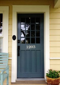 a blue front door with the number 1203 on it