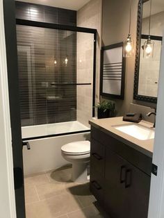 a bathroom with a toilet, sink and bathtub next to a shower stall in the corner