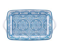 a blue and white tray with an ornate design on the bottom, in front of a white background