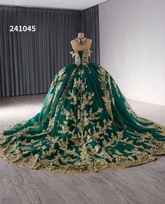 a green and gold wedding gown on display