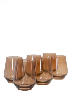 four brown glasses sitting next to each other