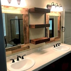 a bathroom with double sinks and two mirrors