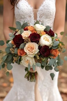 a bridal holding a bouquet of flowers and greenery