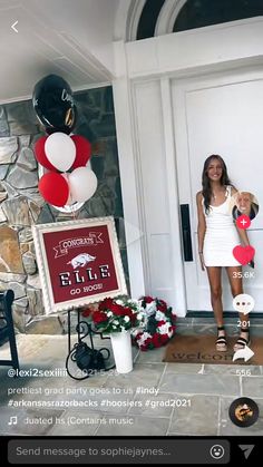 a woman standing in front of a door with balloons and flowers on the side walk