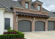 a large brick building with three garages