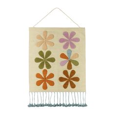 a wall hanging with flowers on it and fringes around the edges in various colors