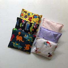 "If your kiddo loves a fun printed bandaid to help their boo-boos disappear then they're going to love these washable ouch pouches. The covers come in a variety of fun prints to help encourage littles to keep ice on that bump or bruise. Store the flax seed insert in the freezer for when your little one needs it and let them choose the Ouch Pouch cover that will make their boo-boo go bye-bye. Then, at the end of the day pop it in the microwave to ease mom and/or dad's aching muscles!  - Finished size 5\" x 5\" - Reinforced seams for durability - Cover is removable and washable - Insert is filled with organic whole flax seed so it wont start to smell like rice does - Use hot or cold - Store in the freezer or heat in 15 second increments for heat pack.  Be careful to heat slowly and move the Boo Bags, Ouch Pouch, Boo Boo Bags, Rice Pack, Hot Cold Packs, Hot Pack, Rice Bags, Cold Pack, Heat Pack