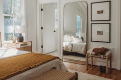 a bedroom with white walls and wooden floors