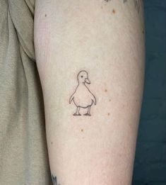 a small duck tattoo on the left arm