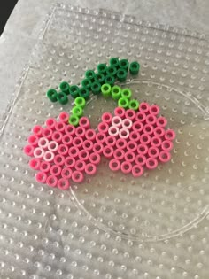 a piece of bead art made to look like two cherries