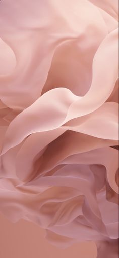 an abstract image of flowing pink fabric