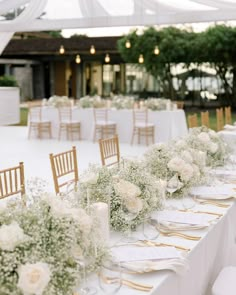 the tables are set with white flowers and candles