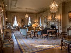 a living room filled with furniture and chandeliers