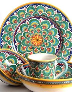 an ornately designed dinner set with matching cups and saucers is featured in this image