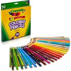 crayon colored pencils are lined up in a box and next to each other