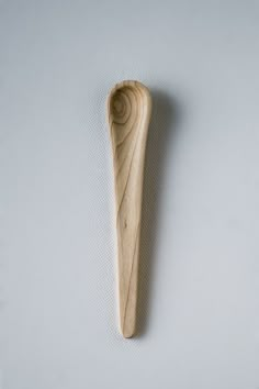 a wooden spoon sitting on top of a white surface