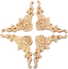 four pieces of carved wood with roses on them