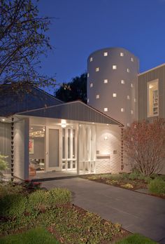 a modern house at night with its lights on