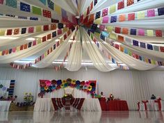 the ceiling is decorated with colorful ribbons and streamers