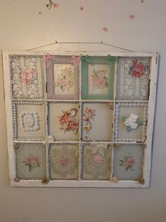 an old window is decorated with pink and white flowers