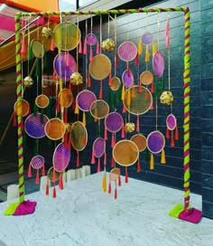 a group of colorful objects hanging from the side of a building