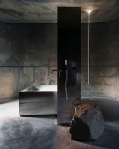 a bathroom with a large rock in the middle