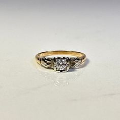 a diamond ring sitting on top of a white table