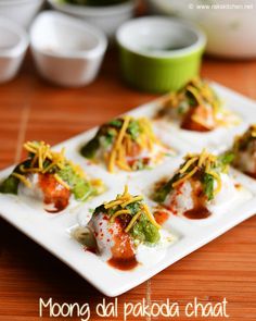 small appetizers are arranged on a white plate