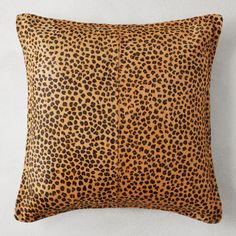 a leopard print pillow on a white wall