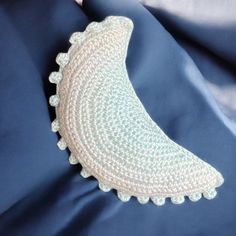 a crocheted banana sitting on top of a blue blanket