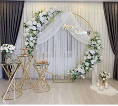 a white and gold wedding set up with flowers