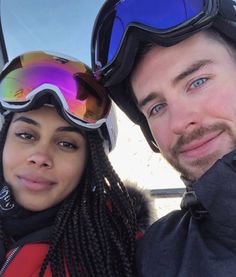 a man and woman with ski goggles on