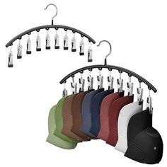 an assortment of hats hanging from hooks on a rack with clippings and clips