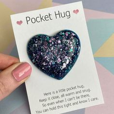 a heart shaped brooch sitting on top of a card