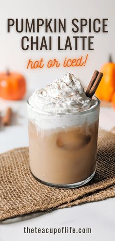 pumpkin spice chai latte in a glass with whipped cream and cinnamon on top