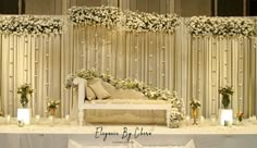 an elegant wedding setup with white flowers and greenery