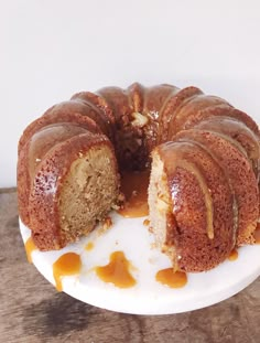 a bundt cake on a white plate with caramel sauce drizzled around it