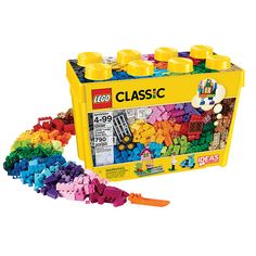 a yellow lego box filled with lots of different colored plastic blocks and toys next to it