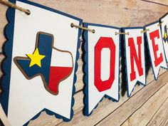 a banner with the word texas on it is hanging from a wooden planked wall