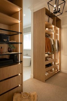 a closet with wooden shelves and lights on the ceiling, along with a handbag