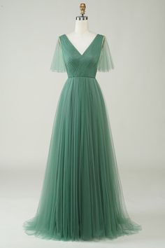 a green dress on a mannequin dummy with an open neckline and tulle skirt